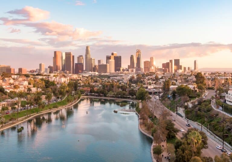 Aerial view of downtown Los Angeles California city skyline and skyscraper buildings during golden hour before sunset.