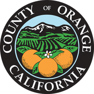Seal of Orange County, California featuring oranges, mountains, and fields.