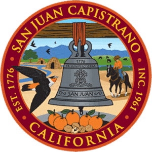 Seal of San Juan Capistrano, CA featuring a bell, falcon, oranges, nuts, horse rider, buildings, birds, and mountains.