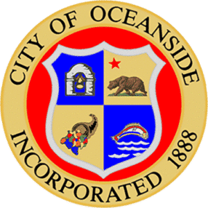 City of Oceanside seal featuring a shield with a star, bear, cornucopia, and fish, encircled by text.